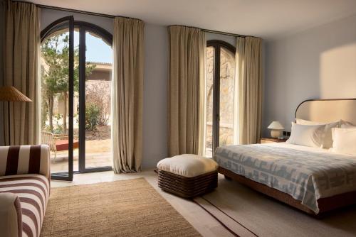 a bedroom with a bed and a large window at Zannier Île de Bendor in Bandol