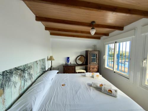a bedroom with a bed with two towels on it at Casa Puerta Azul By Solymar Properties in Almáchar