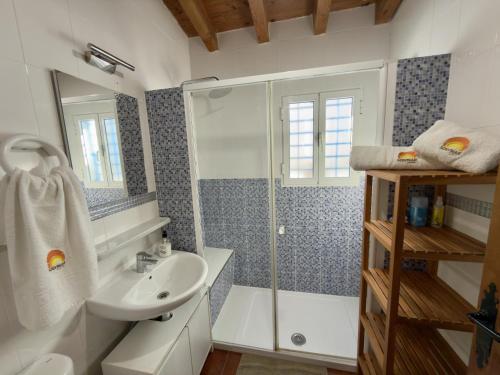 a bathroom with a shower and a sink at Casa Puerta Azul By Solymar Properties in Almáchar