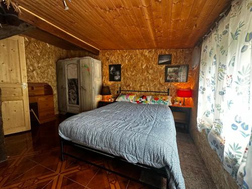a bedroom with a bed and a wooden ceiling at l'Orée des Moraines in Monnet-la-Ville