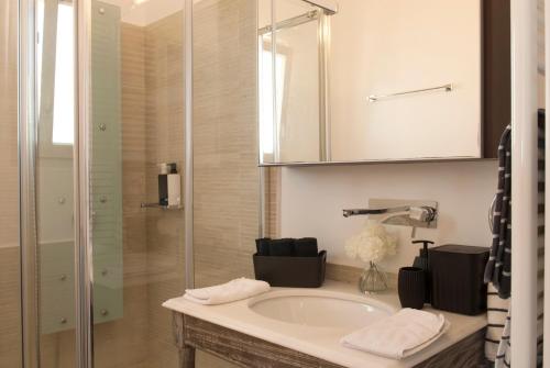 a bathroom with a sink and a shower and a tub at Chrysalis Nature Villa 4 in Kampos Paros