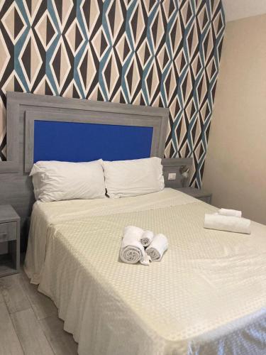 a bedroom with a bed with two towels on it at Club Residence Tropea Pace in Tropea