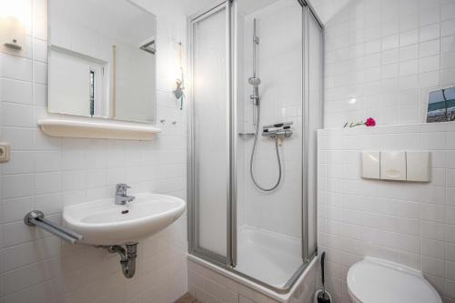 a bathroom with a shower and a sink and a toilet at Seestrasse Haus 15 in Zingst