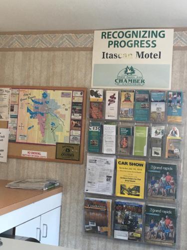 a wall filled with lots of signs and books at Itascan Motel in Grand Rapids