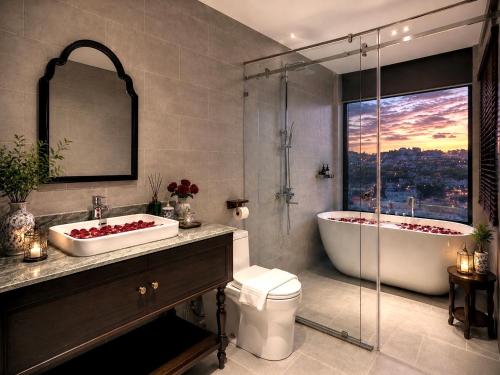 a bathroom with two sinks and a bath tub at Lumina Premium- HT Boutique 2 - Đống Đa in Da Lat