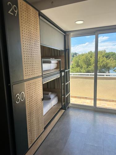 a room with a door with a view of a field at Hostel Petra Marina in Dubrovnik