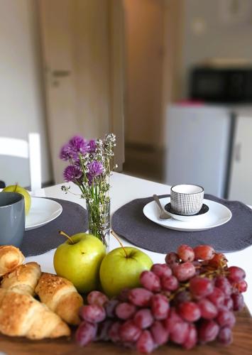 a table with plates of food and fruit on it at apartma Vila TARA in Prebold