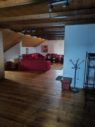 a living room with a red couch and a table at SunKiss in Melnragė