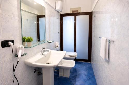 a bathroom with a sink and a toilet and a mirror at B&B Sant'Antonio in Gallipoli