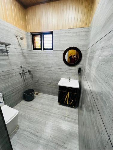 a bathroom with a sink and a mirror at Countryside forest village in Udhampur