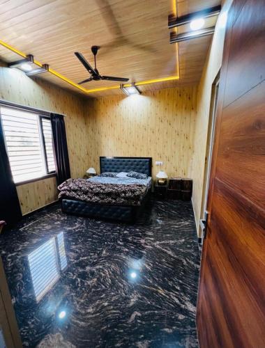 a room with a bed and a ceiling at Countryside forest village in Udhampur