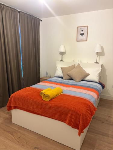 a bedroom with a bed with two towels on it at La Vio Homestay Private Room & Bathroom, Newcastle Dublin in Newcastle
