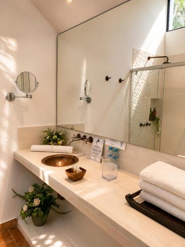 a bathroom with a sink and a mirror at La Masia Hotel Boutique in Anapoima