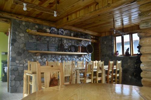 a dining room with a wooden table and chairs at Agape Log Cabin in Sagada