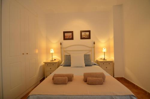 a bedroom with a large bed with two night stands at Playa Grande SOLMARES in Isla del Moral