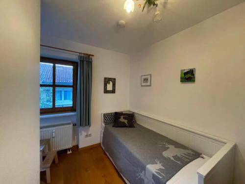 a bedroom with a bed and a window at Ferienwohnung Wildbichl in Sachrang in Sachrang