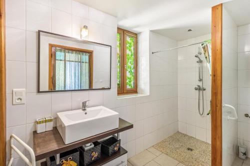 a white bathroom with a sink and a shower at Gite Périgourdin - 2 Chambres in Saint-Geniès