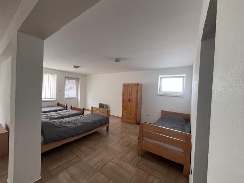 a bedroom with two beds and a window at Prenoćište TG in Tomislavgrad