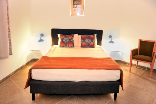 a bedroom with a bed and a chair in it at Mira Beach Resort Bodrum - All inclusive in Bodrum City