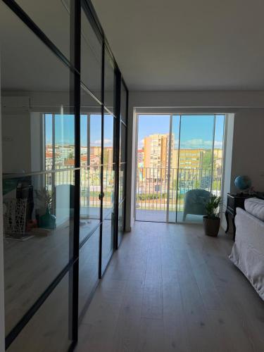 an empty living room with a view of a city at Home2830 in Barreiro