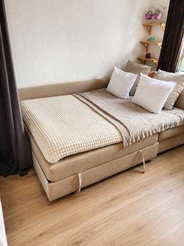 a bed with two pillows on it in a room at Mysig lägenhet i centrum in Västerås