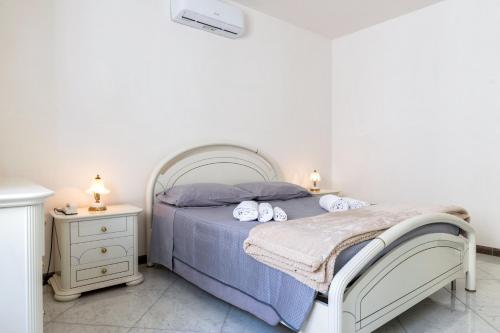 a bedroom with a bed with blue sheets and towels at Villa Montevicoli in Ceglie Messapica