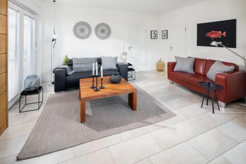 a living room with a couch and a table at Seehaus 48 in Norderney
