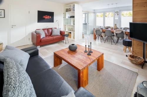 a living room with a couch and a table at Seehaus 48 in Norderney