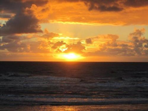 a sunset over the ocean with the sun setting at Las Palmas Hotel by the Sea in Blackpool