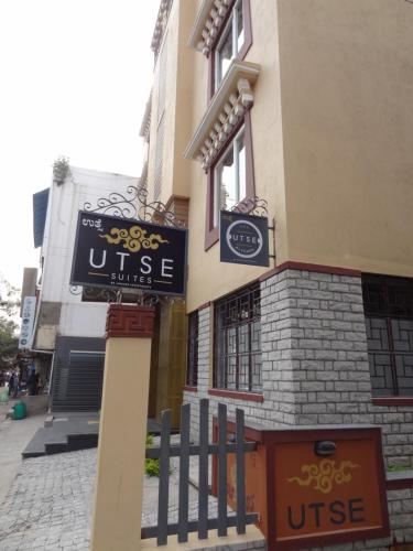 a sign on the side of a building at Utse Suites in Bengaluru