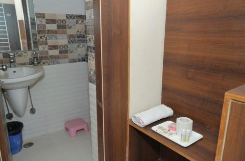 a bathroom with a sink and a toilet and a shower at Hotel Rama palace in Mathura