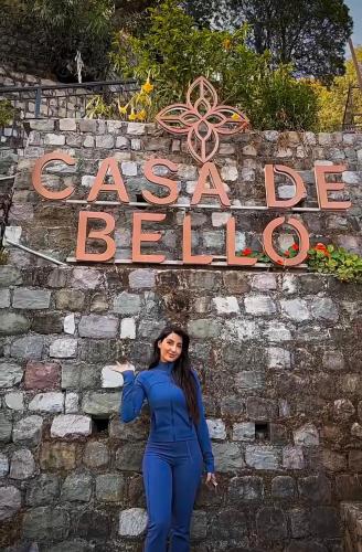 a woman standing in front of a sign at Casa De Bello, Nainital, Near Kainchi Dham in Bhowāli