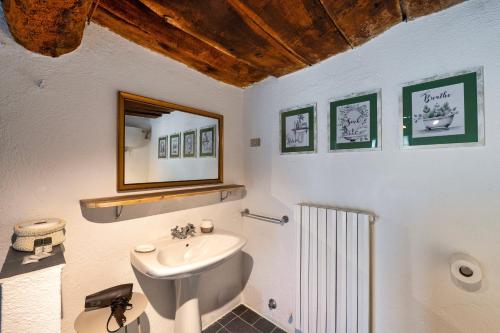 a bathroom with a sink and a mirror on the wall at Assisi Countryhouse in Assisi