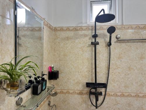 a shower in a bathroom with a shower at Hava Hostel Lang Son in Lạng Sơn