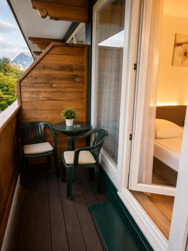 a small balcony with a table and two chairs at Alpine Studio near Bad Ischl in Bad Ischl