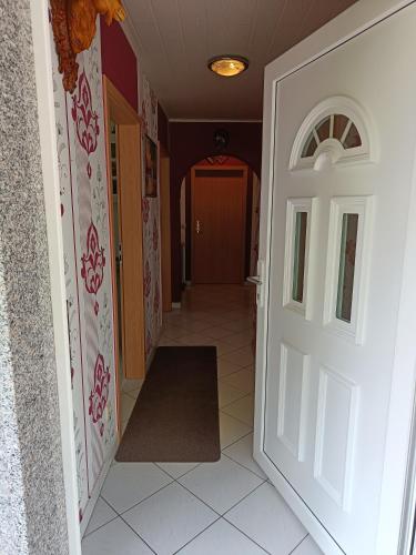 a hallway with a door and a tile floor at Ferienwohnung mit Terrasse Ettringen in Ettringen