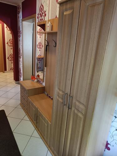 a large wooden cabinet in a room with a kitchen at Ferienwohnung mit Terrasse Ettringen in Ettringen