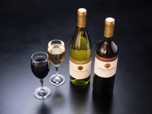 two bottles and two glasses of wine on a table at Hotel Hagoromo in Shizuoka