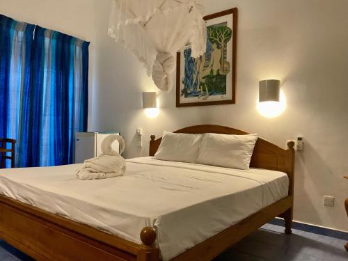 a bedroom with a bed with a stuffed animal on it at Muthukirula Resort in Aluthgama