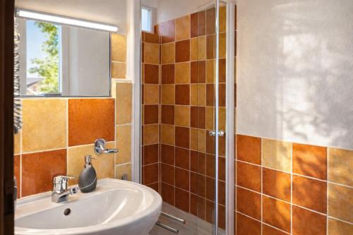 a bathroom with a sink and a shower at Hôtel restaurant Clos des Sullys in Montclus