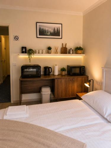 a bedroom with a bed and a microwave on a shelf at Alpine Studio near Bad Ischl#2 in Haiden