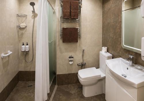 a bathroom with a toilet and a shower and a sink at Nafta Sanatorium in Naftalan