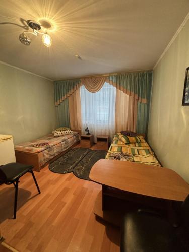 a bedroom with two beds and a window at готель Славутчанка in Slavuta