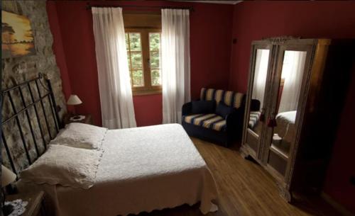 a bedroom with a bed and a chair and a window at Casa Nansi in Berodia