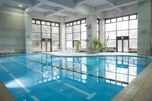 a large pool with blue water in a building at Hakone Forest of Verde in Hakone