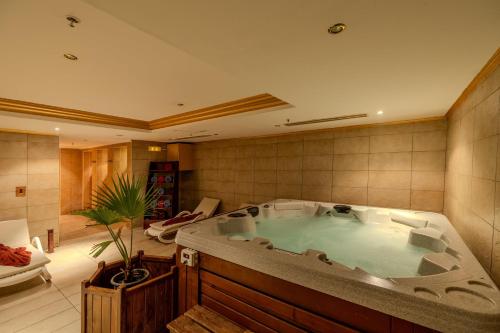 a large bathroom with a large tub in a room at Continental Plaza Beach Resort in Sharm El Sheikh