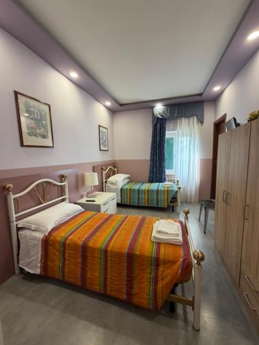 a bedroom with two beds and a window at Do Carioca in Villalvernia