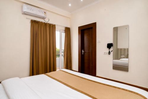 a hotel room with a bed and a window at Evaara By The Ganges A Ganga Access Resort & Jungle Safari in Haridwār