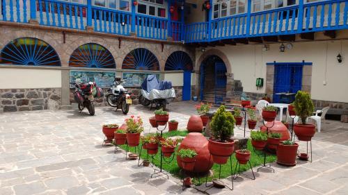 a group of potted plants inront of a building at Casa Grande Colonial Palace in Cusco
