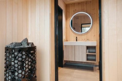 a bathroom with a sink and a mirror next to a counter at Hytter og leiligheter i Kvitfjell - Alpinco in Ringebu